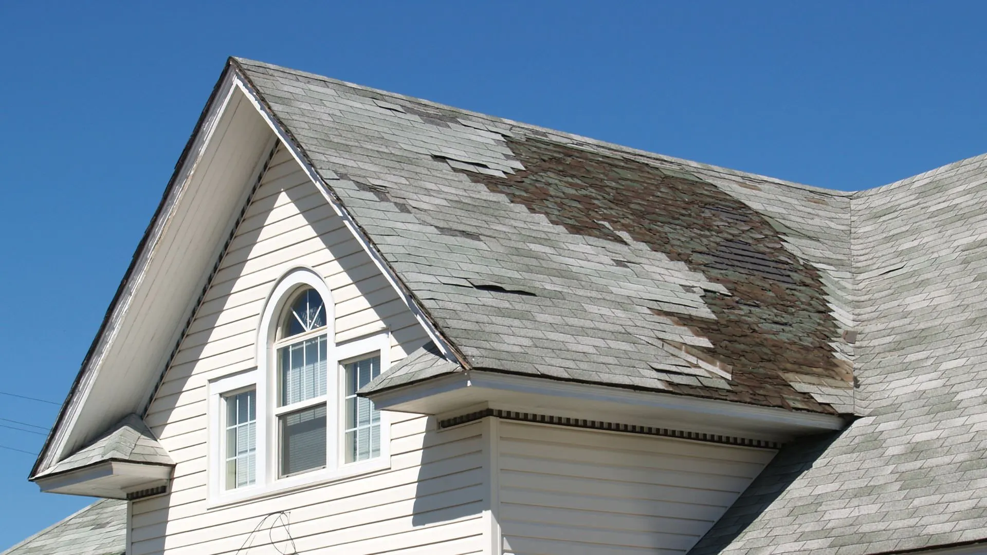 Photo of a damaged roof on a home